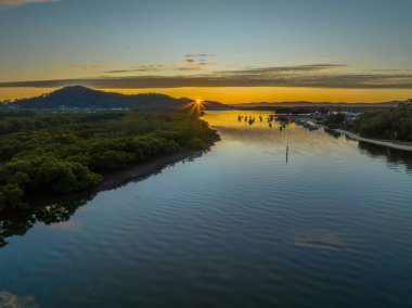 Aerial sunrise over the bay with high cloud at Woy Woy on the Central Coast, NSW, Australia.
