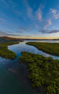 Aerial sunrise over the bay with high cloud at Woy Woy on the Central Coast, NSW, Australia.