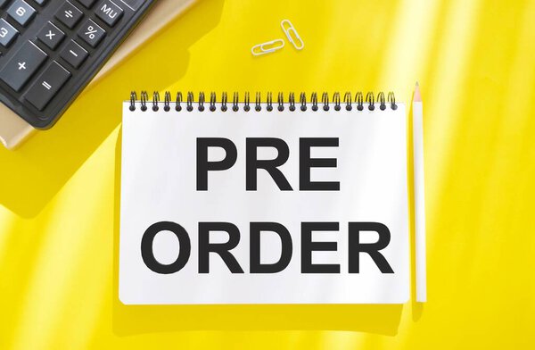 Hand writing the text: Pre-Order, business concep, yellow background