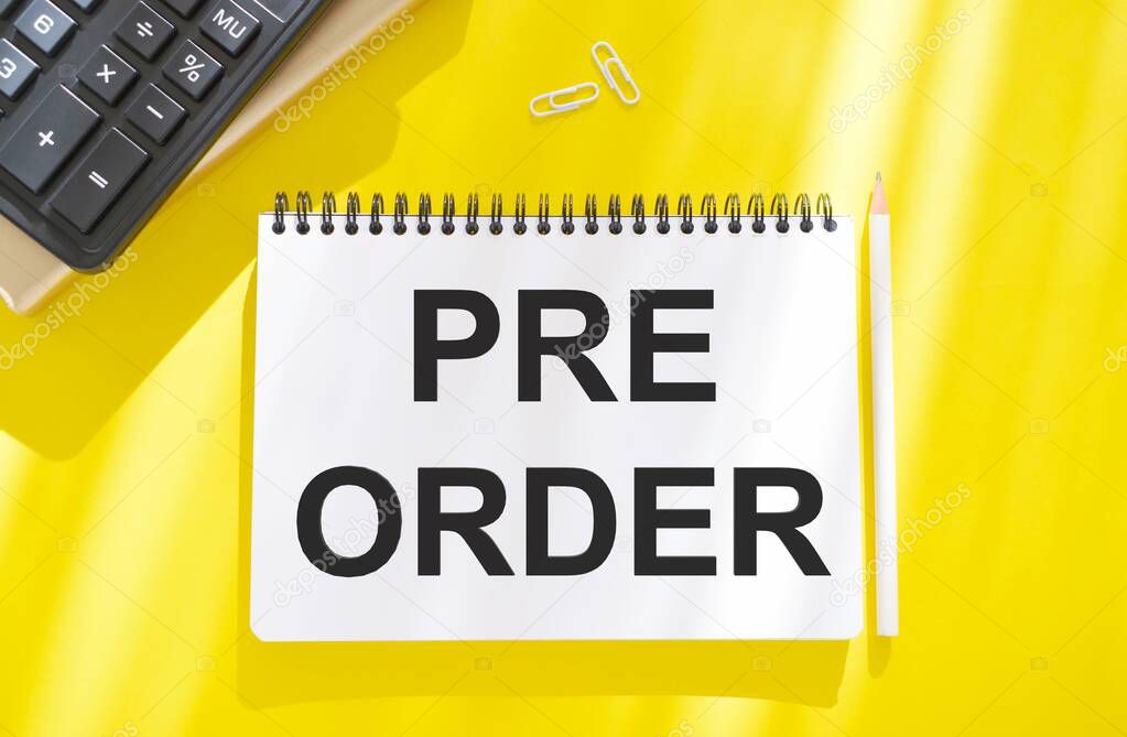 Hand writing the text: Pre-Order, business concep, yellow background