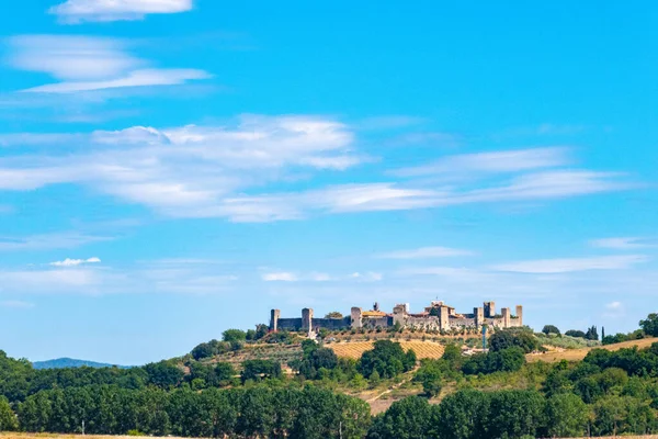 Küçük bir ortaçağ kasabası olan Monteriggioni, güneşli bir yaz gününde Francigena yolundan gökyüzüne yükselir.