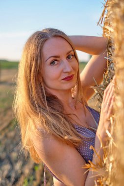 Samanlıkta şapkalı bir kız.