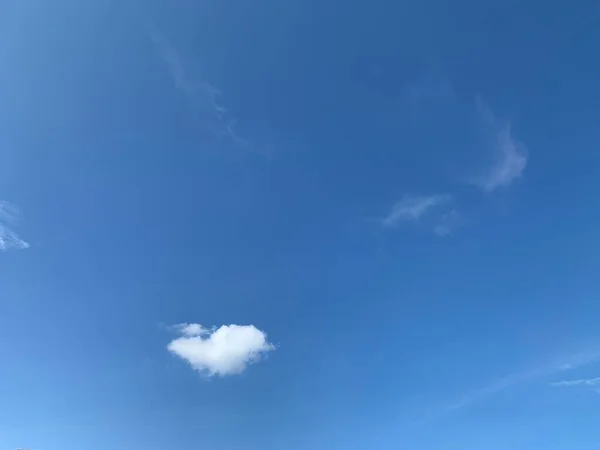 a cloud in blue sky horizontal background