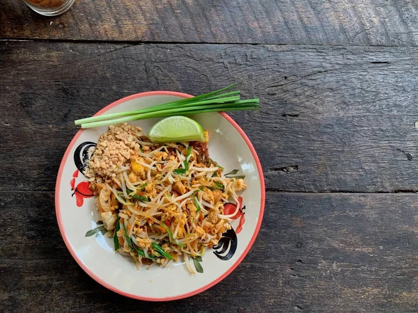 Pad thai or fried noodle thai style on wood table