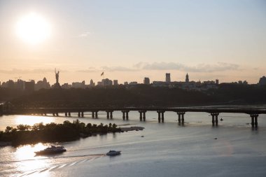 Kyiv şehrinin panoraması kuş bakışı. Gün batımında Dinyeper ve Pechersky bölgesindeki köprü manzarası. Ukrayna 'nın başkentinin şehir manzarası. Ukraynalılar İçin Barış
