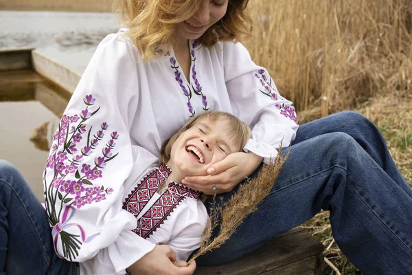 little boy and a young woman in embroidered national clothes are having a happy time. Family, love, unity, support, patriotism. Ukrainians are against the war. Pride to be Ukrainian