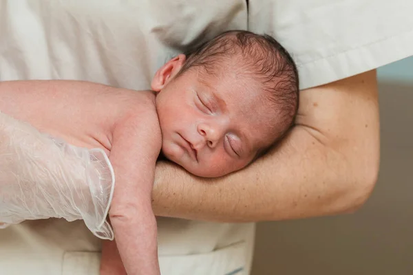 Close up view of a medical doctor holding on arms a newborn baby. — Stock Photo, Image