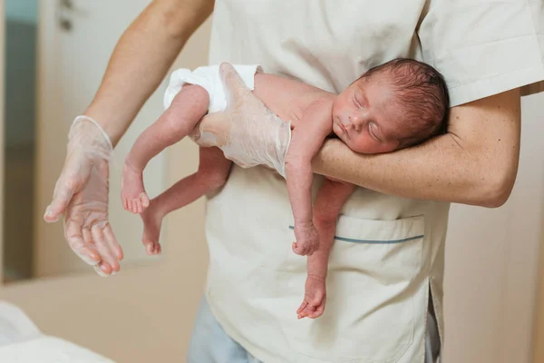 Close up view of a professional physiotherapist working with a newborn baby. — Stok fotoğraf