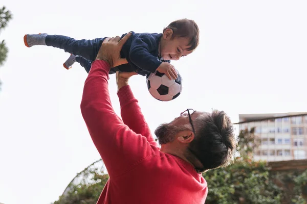 Little boy and his father enjoying playing together with a soccer ball outdoors. — Stock Photo, Image