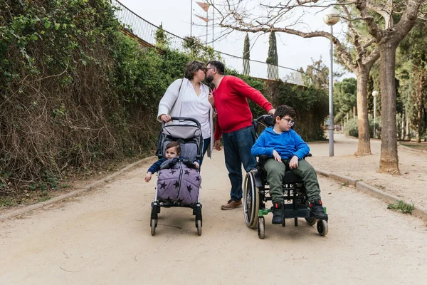 A happy and loving family walking with their children in the park — 스톡 사진