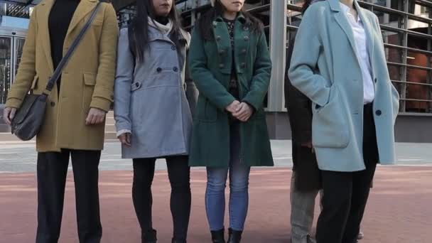 Confident business woman standing in front of her work team outside the office building in the financial district. — Wideo stockowe