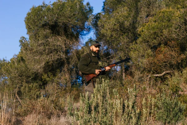 Hunter sétál a szabadban fű pisztollyal — Stock Fotó
