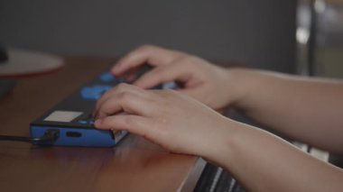 Close-up hands of person with blindness disability using computer keyboard and braille display or braille terminal a technology assistive device for persons with visual impairment.