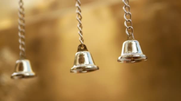 Small Decorative Gold Metal Bells Hanging Swaying Gold Background — Stock video