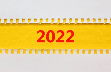 2022 mutlu yeni yıl sembolü. Üzerinde 2022 numarası olan sarı beyaz kağıt. Güzel sarı arkaplan, kopyalama alanı. İş ve 2022 Mutlu yıllar konsepti.