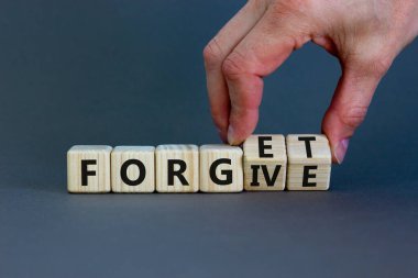 Forgive and forget symbol. Businessman turns wooden cubes and changes the word 'forgive' to 'forget'. Beautiful grey background, copy space. Business, psychological forgive and forget concept. clipart