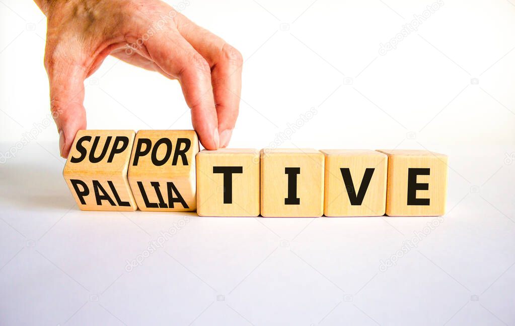 Palliative or supportive therapy symbol. Doctor turns cubes, changes words palliative to supportive. Beautiful white background, copy space. Medical, palliative or supportive therapy concept.