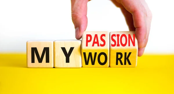 My work or passion symbol. Businessman turns wooden cubes and changes words 'My work' to 'My passion'. Beautiful white table, white background, copy space. Business and my work or passion concept.