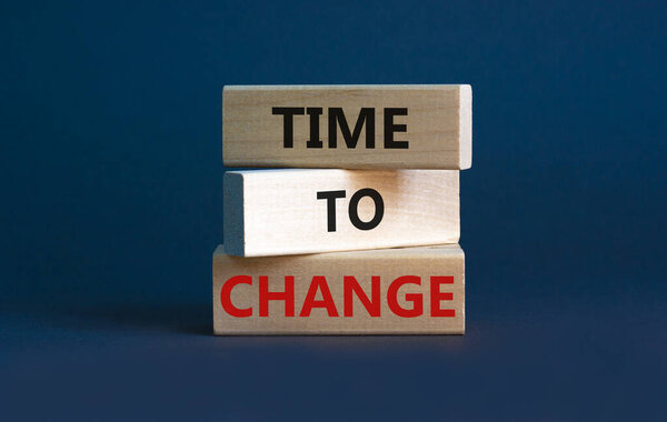 Time to change symbol. Concept words 'Time to change' on wooden blocks. Beautiful grey background. Business and time to change concept. Copy space.