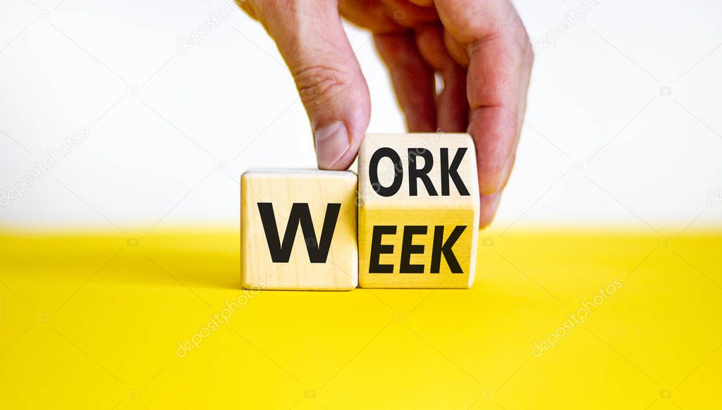 Work week symbol. Businessman turns the wooden cube with words 'Work week'. Beautiful yellow table, white background. Work week and business concept. Copy space.