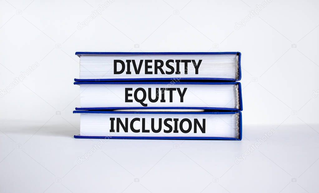 Diversity equity inclusion symbol. Concept words 'Diversity equity inclusion' on books on beautiful white background. Diversity, business, inclusion and equity concept.