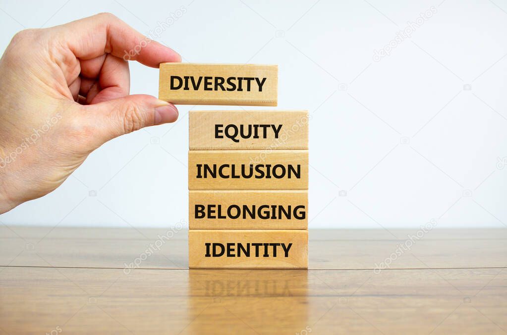 Diversity, equity, inclusion, belonging, identity symbol. Wooden blocks with words Diversity, equity, inclusion, belonging, identity on beautiful white background. Business, Inclusion concept.