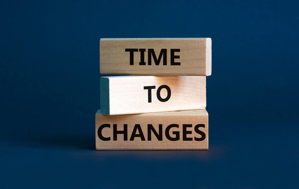 Time to changes symbol. Concept words 'Time to changes' on wooden blocks. Beautiful grey background. Business and time to changes concept. Copy space.
