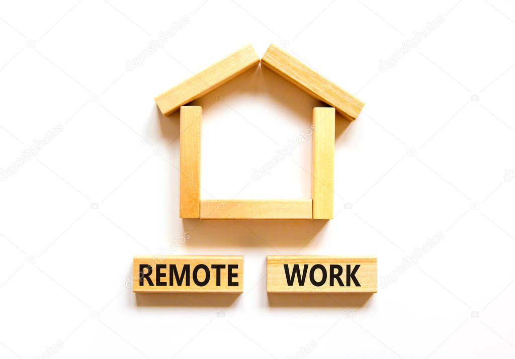 Remote work symbol. Concept words 'Remote work' on wooden blocks near miniature wooden house. Beautiful white background. Business, remote work concept.
