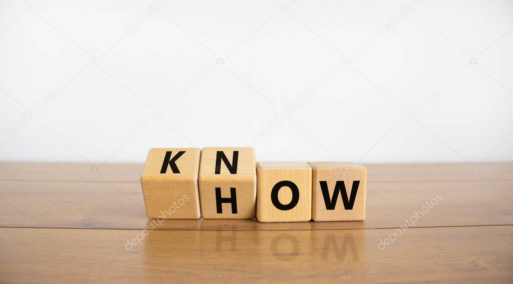Know how symbol. Turned wooden cubes and changed the word 'how' to 'know'. Beautiful wooden table, white background. Copy space. Business and know how concept.