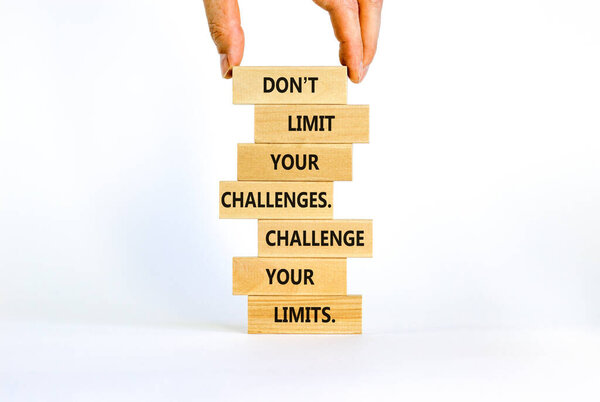 Do not limit your challenges symbol. Wooden blocks with words Do not limit your challenges. Challenge your limits. Beautiful white background, copy space. Businessman hand. Business concept.