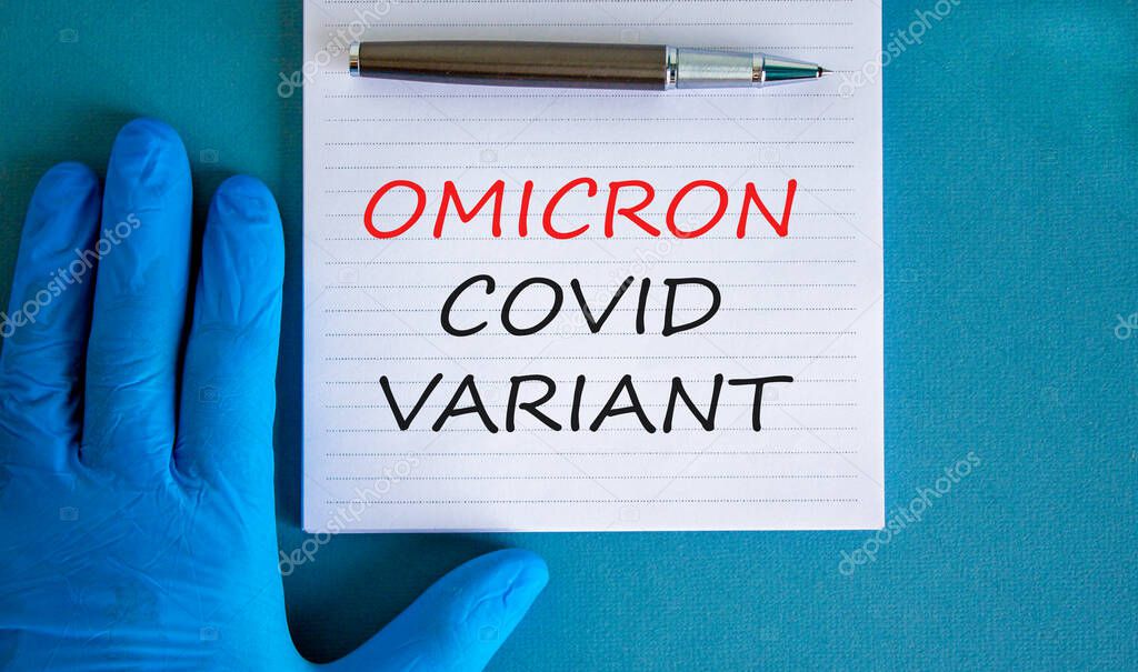 New covid-19 omicron variant strain symbol. Hand in blue glove with white note. Concept words Omicron covid variant. Metalic pen. Medical and COVID-19 omicron variant strain concept. Copy space.