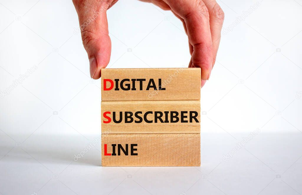 DSL digital subscriber line symbol. Concept words DSL digital subscriber line on wooden blocks. Beautiful white background, businessman hand, copy space. Business DSL digital subscriber line concept.