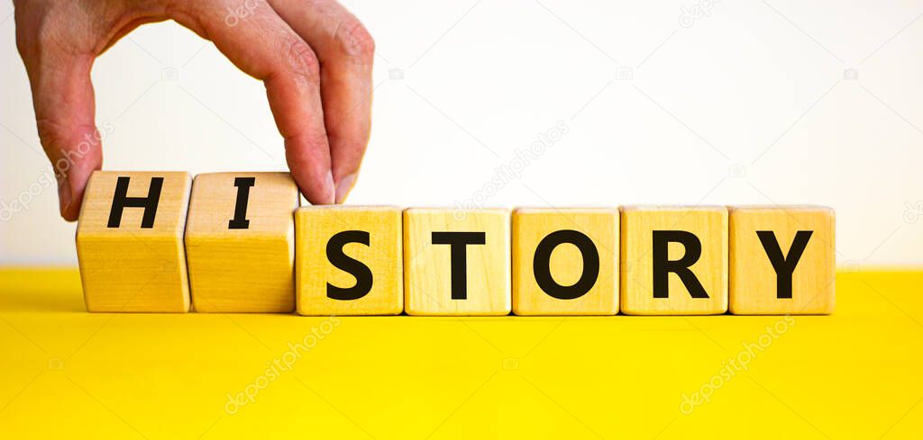 Story and history symbol. Historic turns a cube, changes the word story to history. Beautiful yellow table, white background. Business, historical and story or history concept. Copy space.