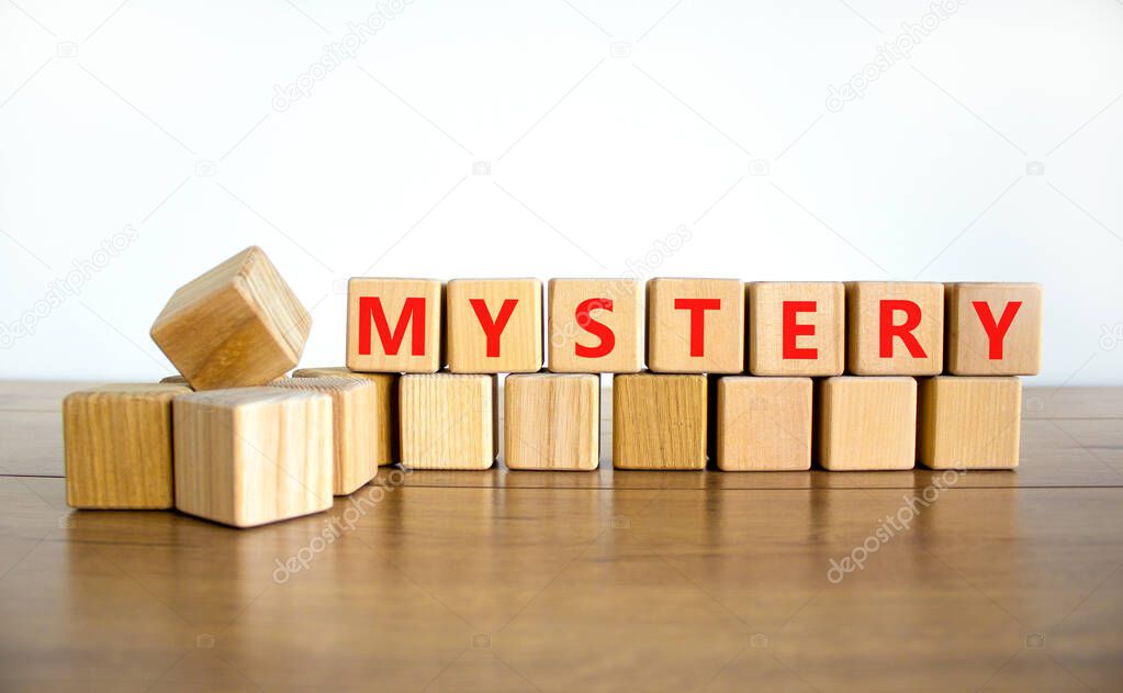 Mystery symbol. The concept word Mystery on wooden cubes. Beautiful wooden table, white background, copy space. Business and mystery mysterious concept.