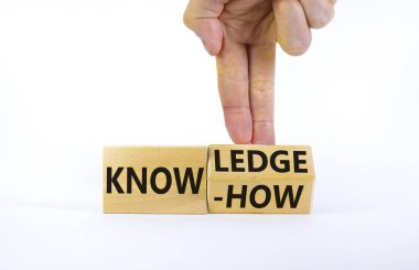 Knowledge and know-how symbol. Businessman turns cubes, changes the word know-how to knowledge. Beautiful white background, copy space. Business, knowledge and know-how concept.