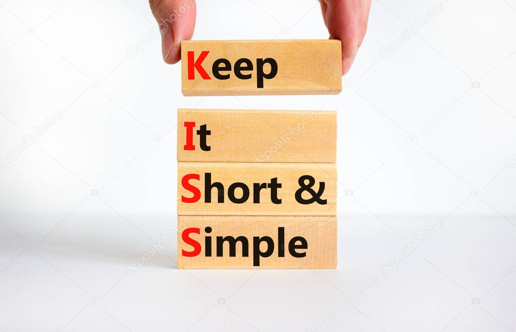 KISS keep it short and simple symbol. Concept words KISS keep it short and simple wooden blocks. Beautiful white table, white background. Business KISS keep it short and simple concept. Copy space.