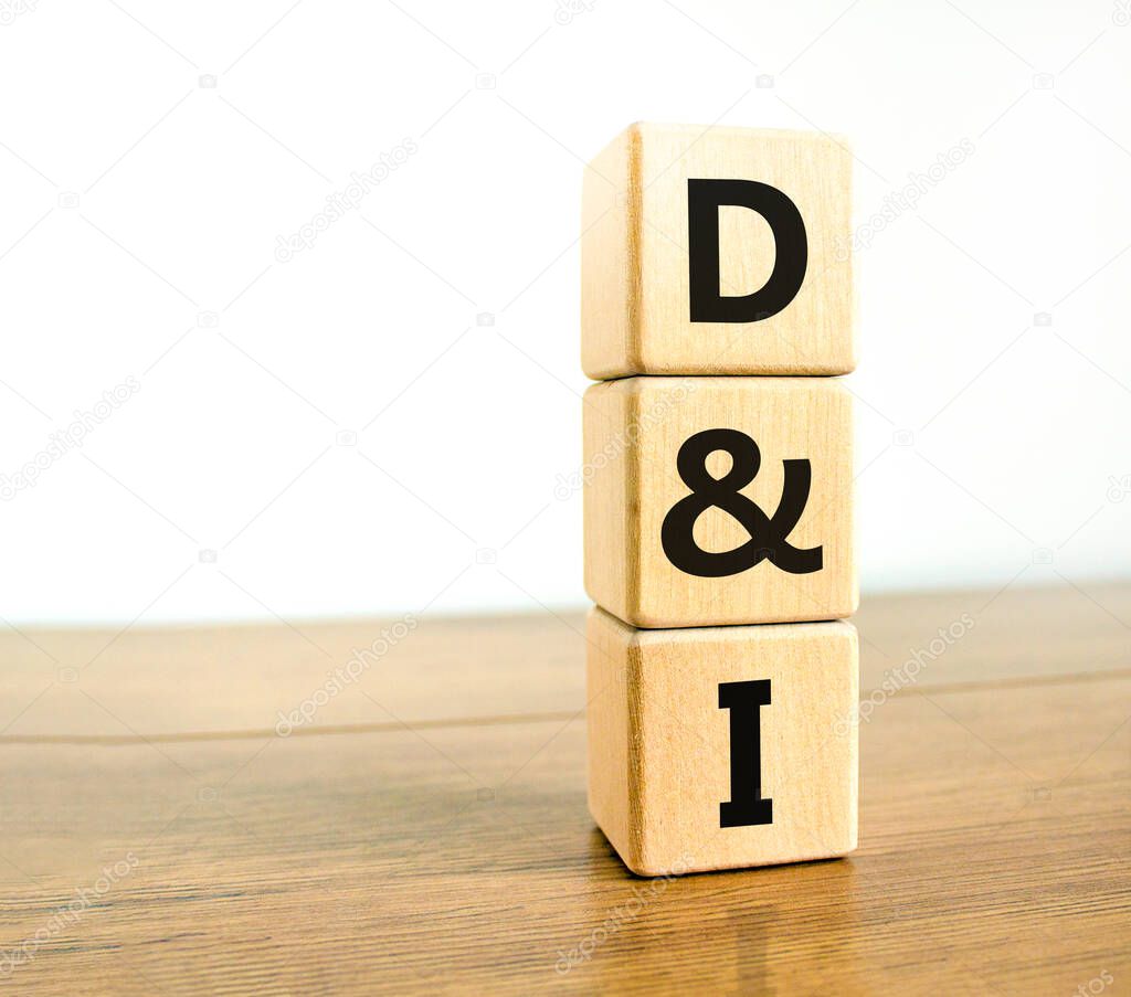 D and I, Diversity and inclusion symbol. Concept words D and I, diversity and inclusion on wooden cubes on beautiful wood table, white background. Business, D and I, diversity and inclusion concept.