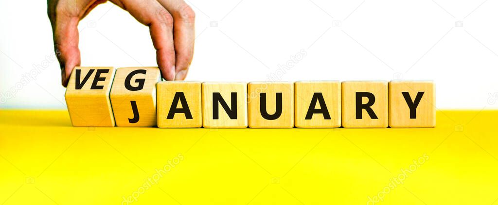 Veganuary in january symbol. Doctor turns wooden cubes and changes the concept word january to veganuary. Beautiful white background copy space. Medical and healthy veganuary in january concept.
