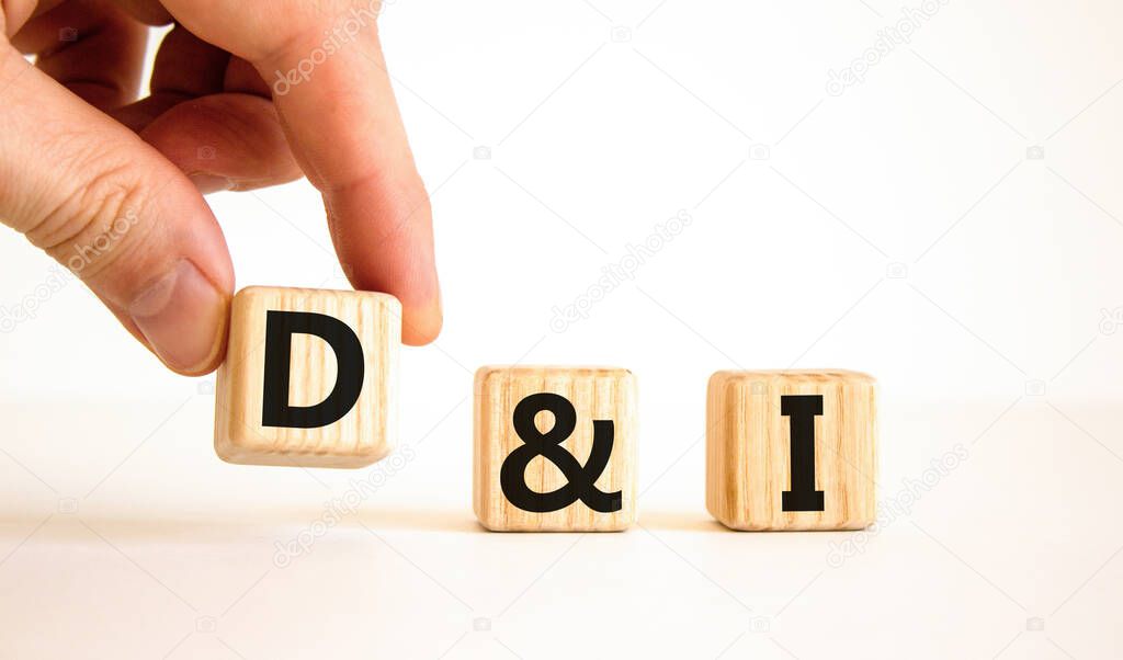 D and I, Diversity and inclusion symbol. Concept words D and I, diversity and inclusion on wooden cubes on beautiful white background. Business, D and I, diversity and inclusion concept.