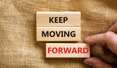 İlerlemeye devam et. Kavramsal kelimeler güzel tuval masa örtüsü arka planında bloklar üzerinde ilerlemeye devam eder. İşadamı eli. İş, motivasyon ve ilerlemeye devam et. Boşluğu kopyala.