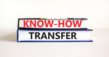 Ne kadar iyi bir transfer sembolü. Güzel beyaz masa arkaplanındaki kitaplara aktarılan kavramsal kelimeler, kopyalama alanı. İş, yenilik ve bilgi aktarım konsepti.