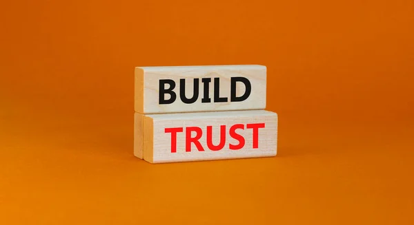 树立信任的象征 概念词在漂亮的橙色桌子背景上的木块上建立信任 业务和建立信任概念 复制空间 — 图库照片