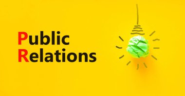 Halkla ilişkiler sembolü. Halkla ilişkiler kavramları. Yeşil ampul simgesi. Güzel sarı arka plan. Uzayı kopyala İş ve Halkla İlişkiler kavramı.