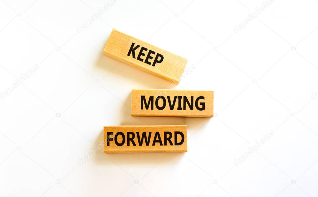 Keep moving forward symbol. Concept words Keep moving forward on blocks on beautiful white table white background. Business, motivation and keep moving forward concept. Copy space.
