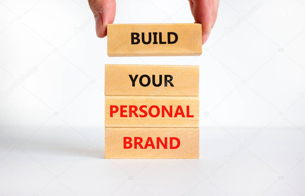 Build your personal brand symbol. Concept words Build your personal brand on wooden blocks. Businessman hand. Beautiful white background. Build your personal brand business concept. Copy space.