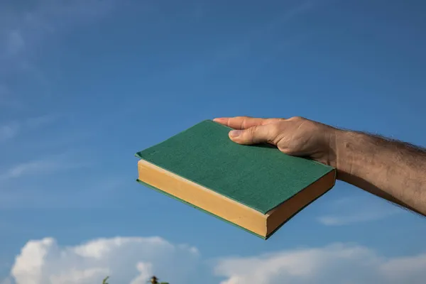 Hand Holding Green Book Cloudy Blue Sky Selective Focus — Stock Photo, Image