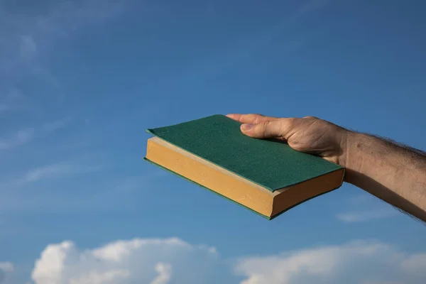 Hand Holding Green Book Cloudy Blue Sky Selective Focus — Stock Photo, Image