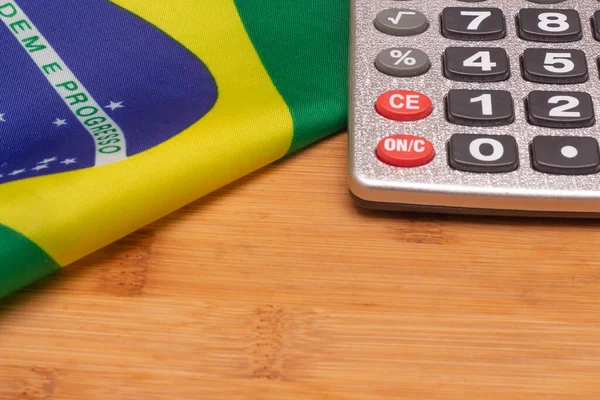 LAURO DE FREITAS, BRASIL - JULY 21, 2022 : brazilian flag next to a calculator