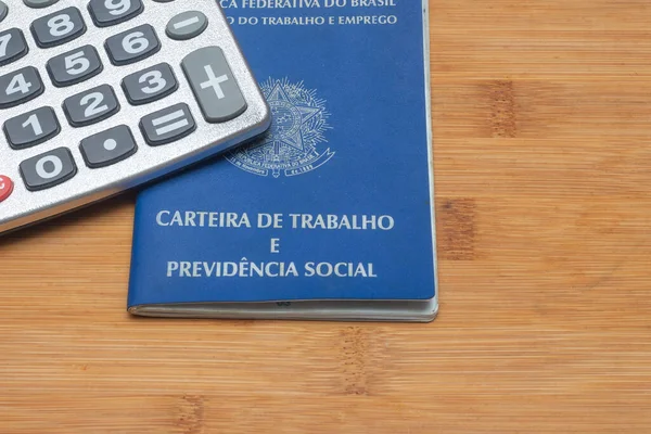 LAURO DE FREITAS, BRASIL - JULY 21, 2022 : brazilian work document with a calculator