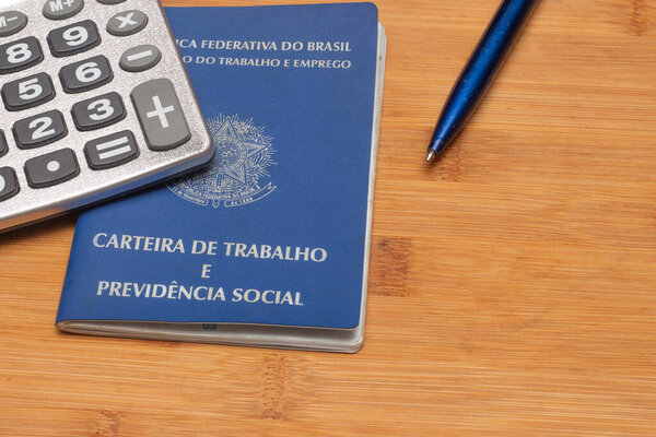 LAURO DE FREITAS, BRASIL - JULY 21, 2022 : brazilian work document with a calculator